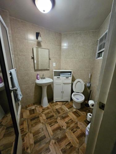 a bathroom with a sink and a toilet and a mirror at Villas Serena Rosarito in Rosarito Beach
