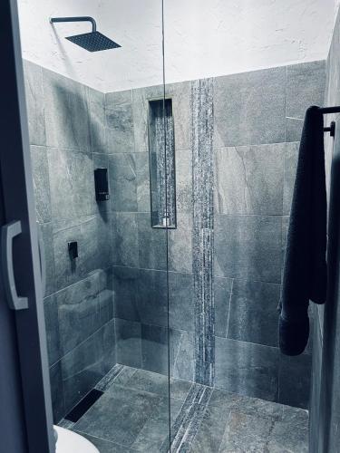 a bathroom with a shower with a glass door at Casa Campamento in La Cueva
