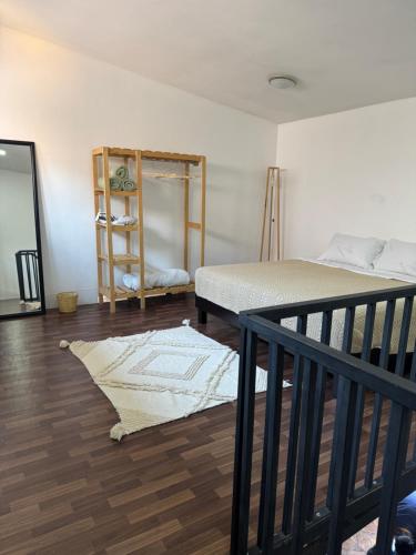 a room with two beds and a book shelf at Minimalist loft 3 blocks from the Zócalo in Oaxaca City