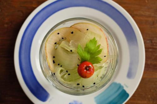 a jar of pickles and a tomato on a plate at Oasi Galbusera Bianca in Rovagnate