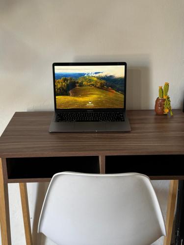a laptop computer sitting on top of a wooden desk at Minimalist loft 3 blocks from the Zócalo in Oaxaca City