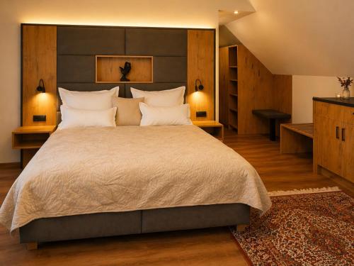 a large bedroom with a large bed with white pillows at KOASA HOF Bed and Breakfast in Oberhaag