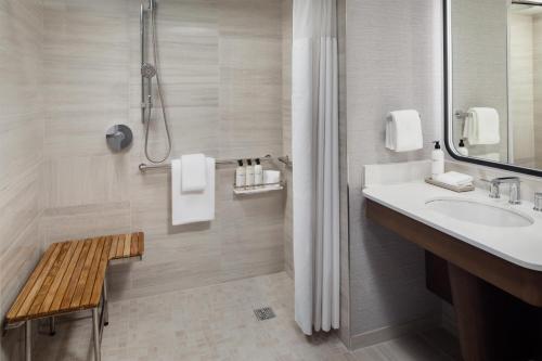 a bathroom with a sink and a shower at Grand Hyatt DFW Airport in Irving