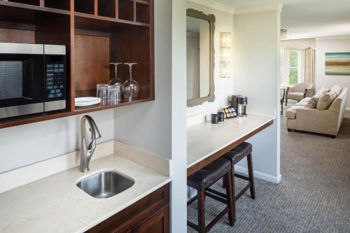 a kitchen with a sink and a microwave at The Elms Hotel & Spa, a Destination by Hyatt Hotel in Excelsior Springs
