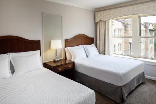 a hotel room with two beds and a window at The Elms Hotel & Spa, a Destination by Hyatt Hotel in Excelsior Springs
