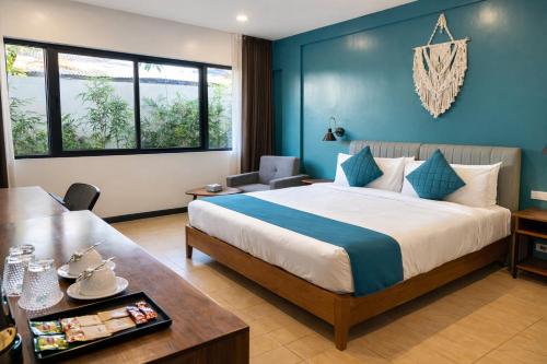 a hotel room with a bed and a table at Hudor Resort - Bauang, La Union in Lossoc