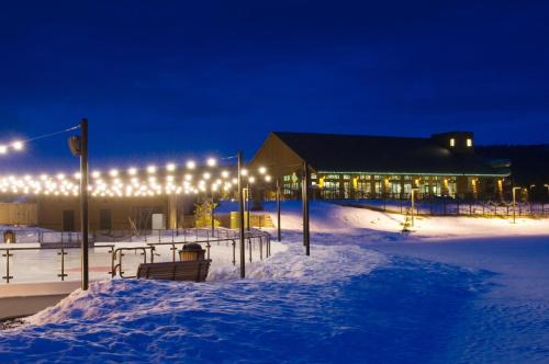 a building with lights in the snow at night at Suncadia Resort in Cle Elum