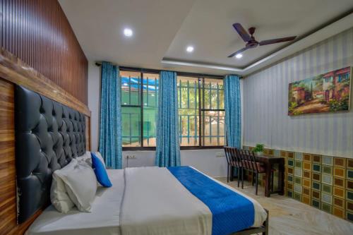 a bedroom with a large bed and a window at Da Down Resort & Hotel in Candolim
