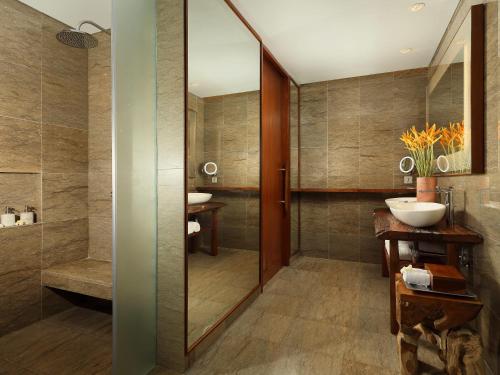a bathroom with a glass shower and a sink at Maya Ubud Resort & Spa in Ubud