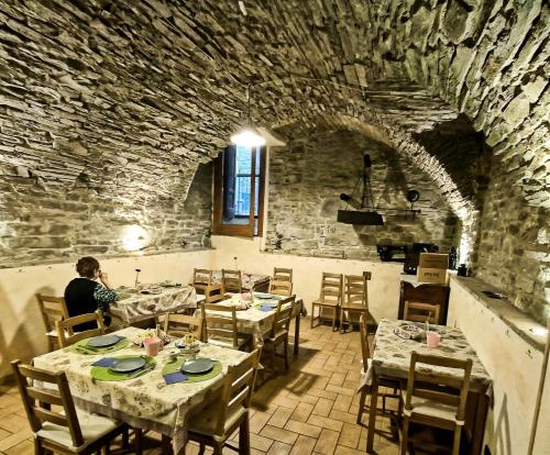 a man sitting at a table in a restaurant at La Casa dei Nonni in Berceto