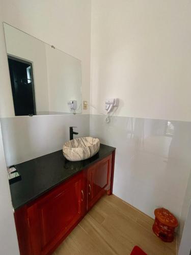 a bathroom with a sink and a mirror on the wall at Happy Villa in Phú Hiệp