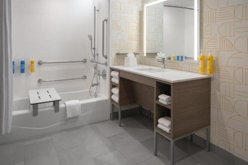 a bathroom with a sink and a tub and a shower at Home2 Suites By Hilton Spring Hill in Spring Hill