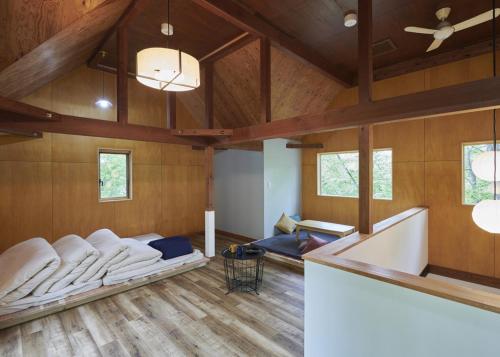 a large living room with a couch and a ceiling at 森のRetreat -foresta di luce- in Hatsukaichi