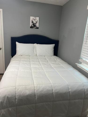 a large white bed in a room with a window at Sweet spot Stone Mountain in Stone Mountain