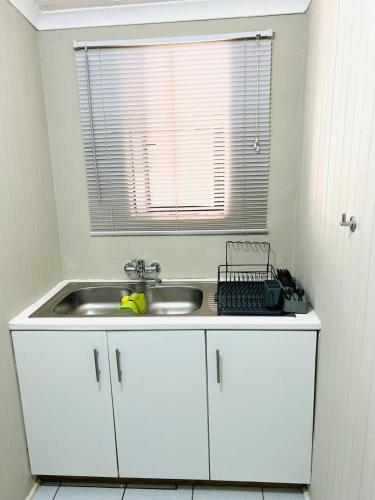a kitchen counter with a sink and a window at Briar & Bloom 1 in Hilton