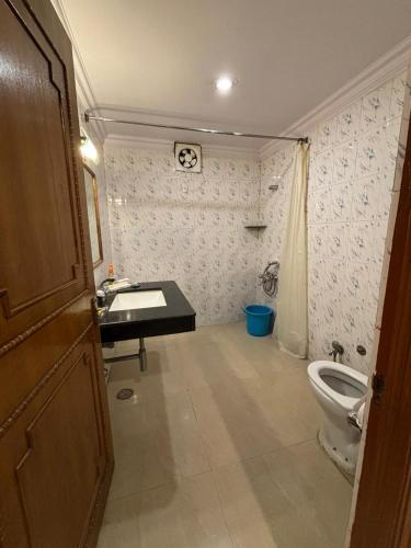 a bathroom with a sink and a toilet at The Backpacker hostel by Surendra rajak in Khajurāho