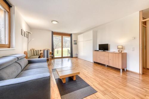 a living room with a couch and a tv at Gartenappartement Kirchdorf by A-Appartments in Brand