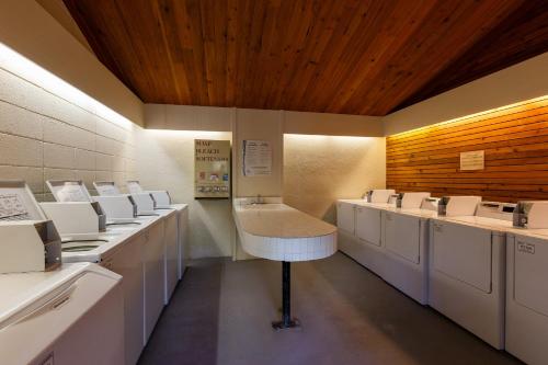 a row of washers and dryers in a bathroom at Pines #2124 in Keystone