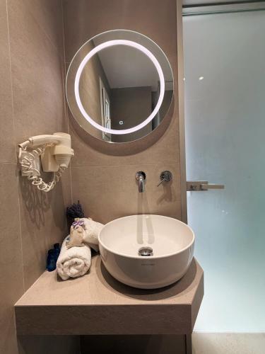 a bathroom with a sink and a mirror at Evripidis Hotel Afitos in Afitos