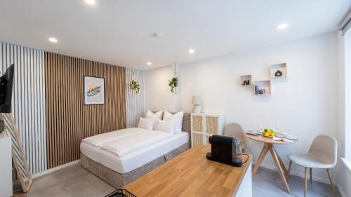 a small bedroom with a bed and a table at City Apartments in Rostock