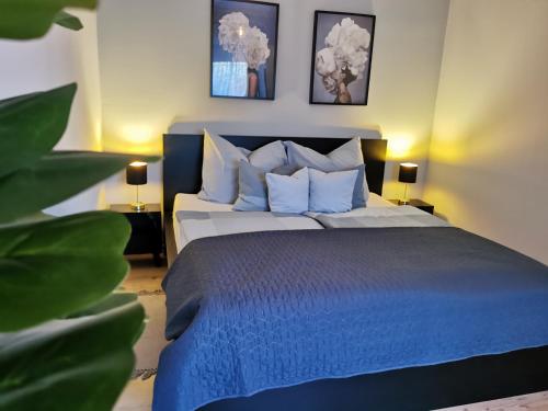 a bedroom with a bed with blue sheets and pillows at Messzikék in Egerszalók