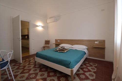 a bedroom with a bed with a blue blanket at Mastru Cicciu in Custonaci