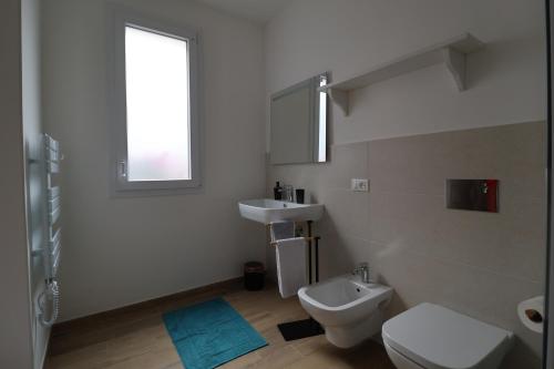 a bathroom with a white toilet and a sink at Mastru Cicciu in Custonaci
