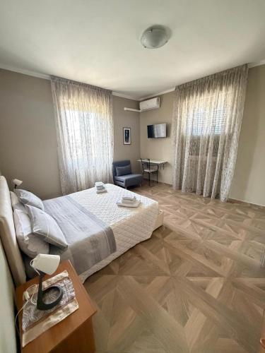 a bedroom with a bed and a chair and a table at B&B da Giusy in Chieti