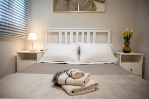 a bedroom with a bed with towels on it at Casa Mary Aegina in Egina