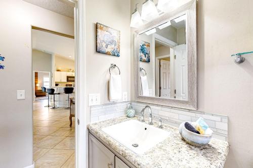 a bathroom with a sink and a mirror at 620 S Easy St in Sebastian