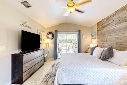 a bedroom with a large bed and a flat screen tv at 620 S Easy St in Sebastian