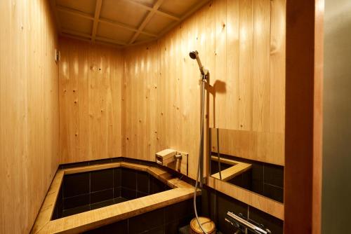a bathroom with a bath tub with a shower at 満竹華庵 manchikan in Tokyo