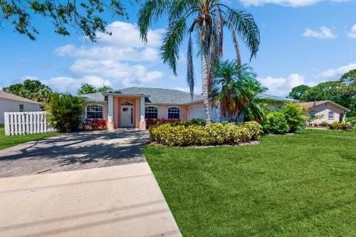 a house with a palm tree in a yard at 1295 Barber St in Sebastian