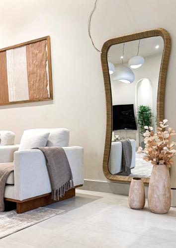 a bedroom with a bed and a large mirror at Cliff Chalet-Amrat in Al Amarat