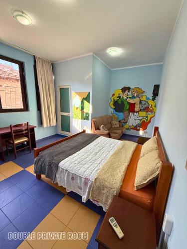 a bedroom with a large bed and a living room at The Galley Party Hostel in Shkodër