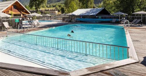 a person swimming in a large swimming pool at Huttopia Val Cenis in Val Cenis