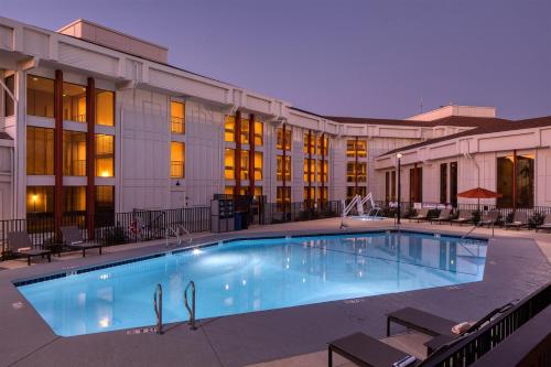 a large swimming pool in front of a building at DoubleTree By Hilton Sacramento in Sacramento