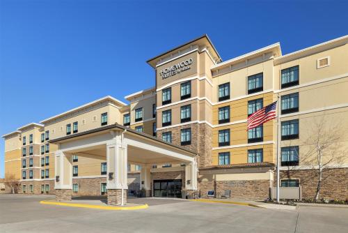 a hotel with an american flag in front of it at Homewood Suites by Hilton West Des Moines/SW Mall Area in West Des Moines