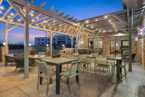an outdoor patio with tables and chairs and lights at Homewood Suites by Hilton West Des Moines/SW Mall Area in West Des Moines