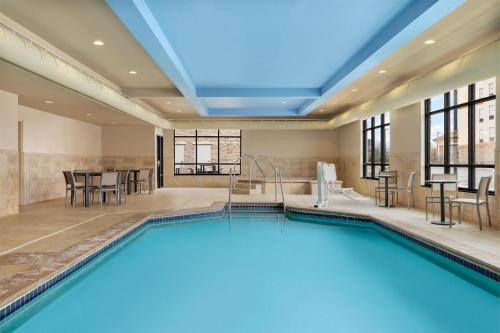 a pool in a hotel room with a poolside at Homewood Suites by Hilton West Des Moines/SW Mall Area in West Des Moines