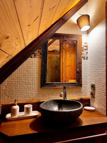 a bathroom with a black sink and a mirror at Authentic chalet in Saint-Jean-dʼArves