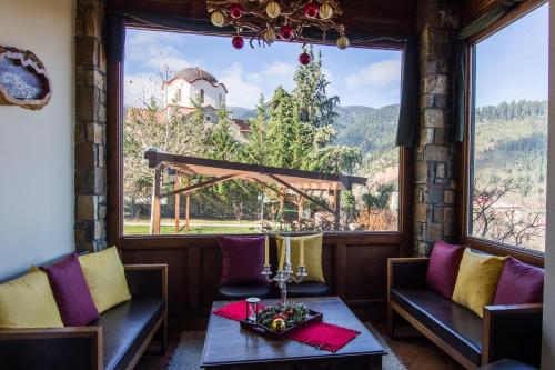 a room with a table and chairs and a large window at Studio Merses in Mikrón Khoríon