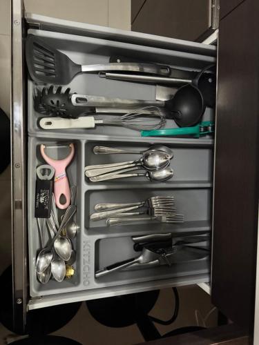 a drawer filled with lots of kitchen utensils at Maikhao Beach Condominium in Mai Khao Beach