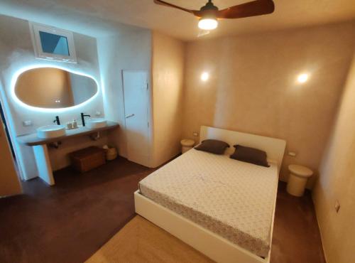 a bedroom with a bed and a bathroom with a sink at local diamond in Guía de Isora