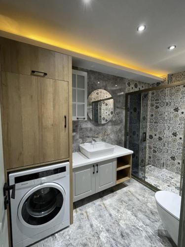 a bathroom with a washing machine and a sink at Villa Gaia in Selçuk