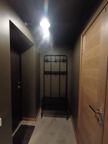 a hallway with a bed in a room with a door at Robezu apartments 14 in Riga