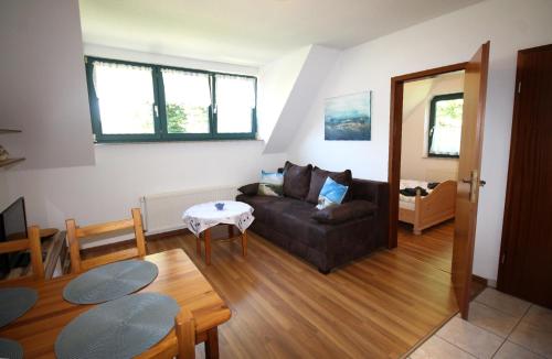 a living room with a couch and a table at Deichkoje 06 in Prerow