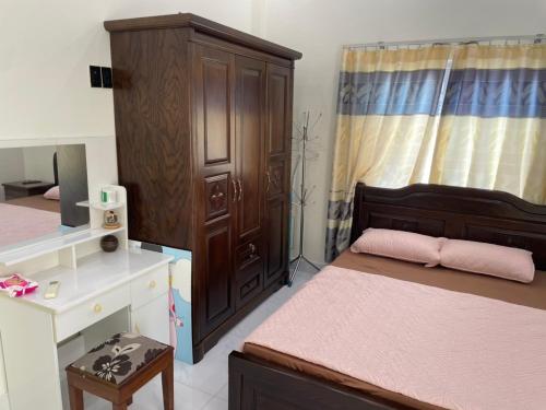 a small bedroom with a bed and a dresser at Beachside home 2 in Phú Quốc