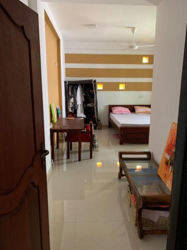a room with a room with a bed and a table at AR 7 Villa Mirissa in Matara