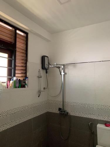 a bathroom with a shower with a shower head at AR 7 Villa Mirissa in Matara